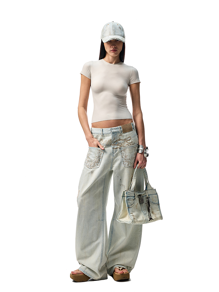 Distressed Mud-Dyed Low-Rise Scimitar Jeans – Wide-Leg Banana Pants